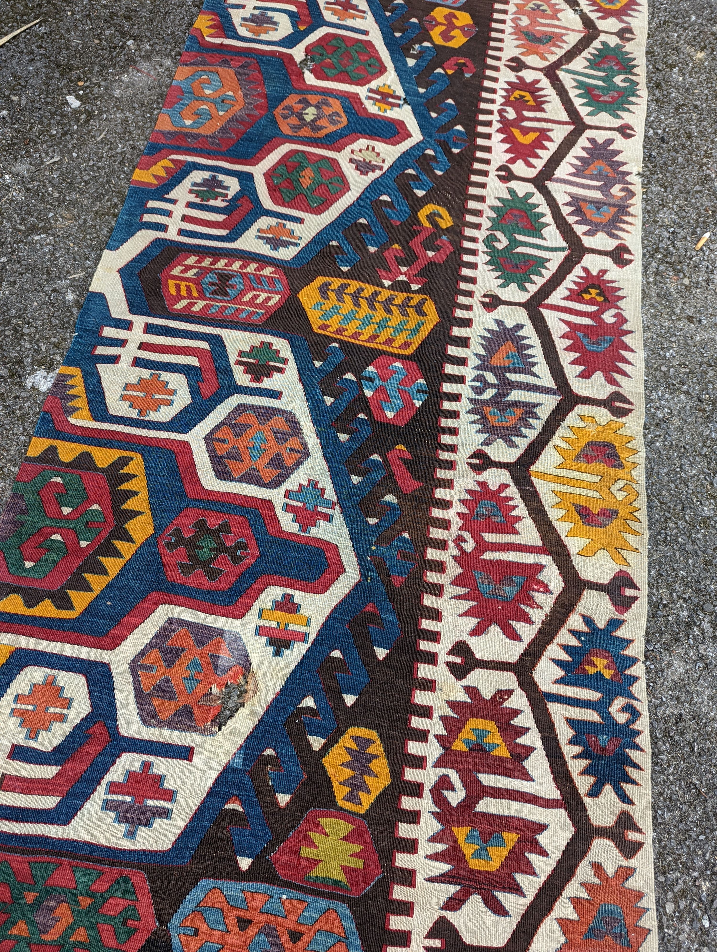 A large Kilim flatweave runner, 400 x 92cm (holed and cut)